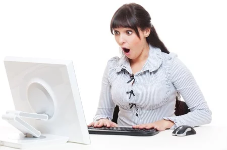 surprised woman staring at a computer screen surprised woman staring at a computer screen