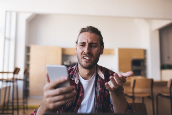 Angry-Person-Navigating-Website-On-His-Phone Angry person navigating website on his phone