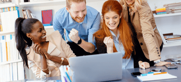 A group of people looking at a laptop