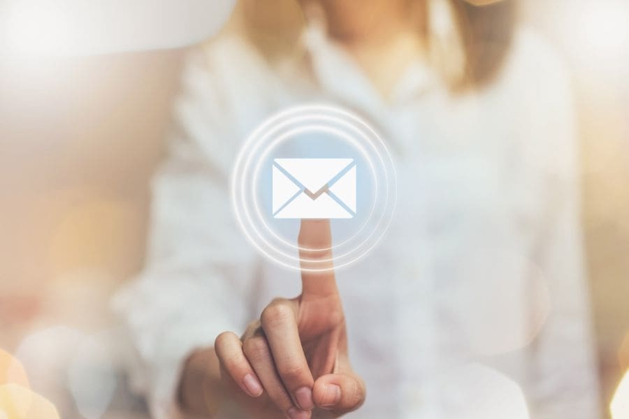 Hand of business woman pressing email